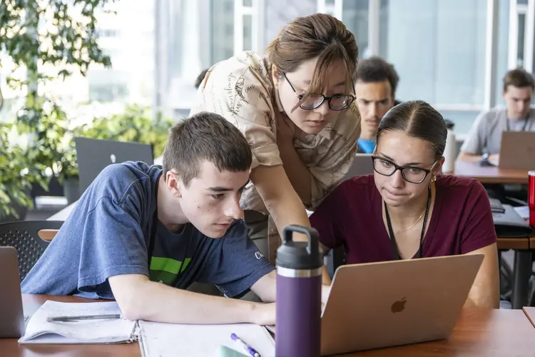 Students receive guidance from an instructor.